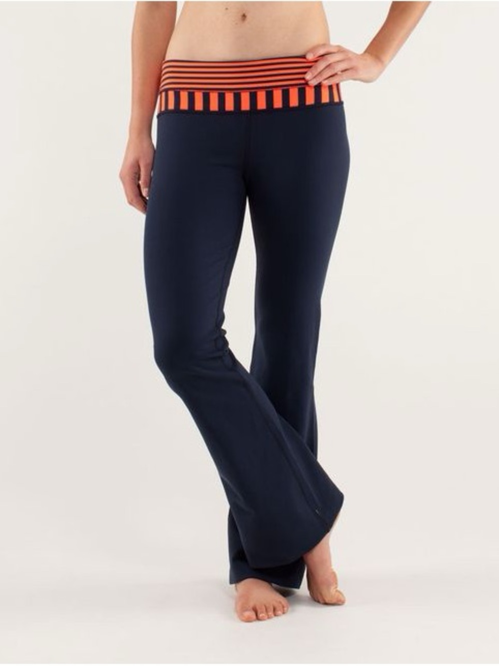 #11 Lululemon Groove navy flare pants featuring a striped orange waistband